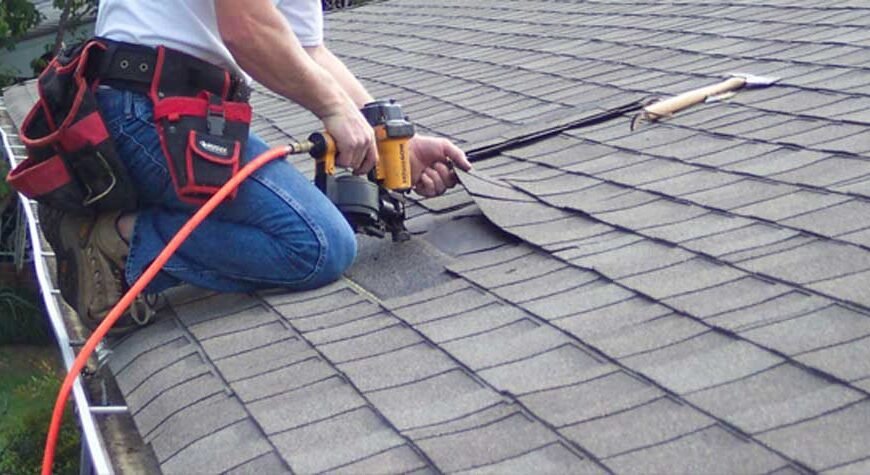 professional roofer repairing roof